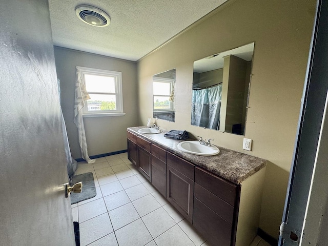 26812 US-150 Hwy, Leroy, IL 61752 - full bathroom featuring double vanity, tile patterned floors, a textured ceiling, baseboards, and a shower with curtain
