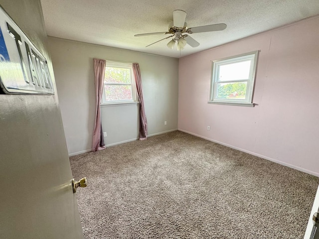 26812 US-150 Hwy, Leroy, IL 61752 - unfurnished room with carpet floors, ceiling fan, baseboards, and a textured ceiling