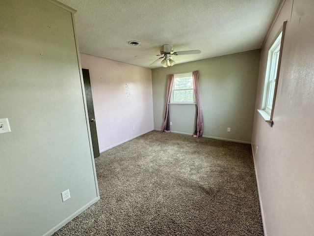 26812 US-150 Hwy, Leroy, IL 61752 - carpeted spare room featuring ceiling fan, a textured ceiling, and baseboards