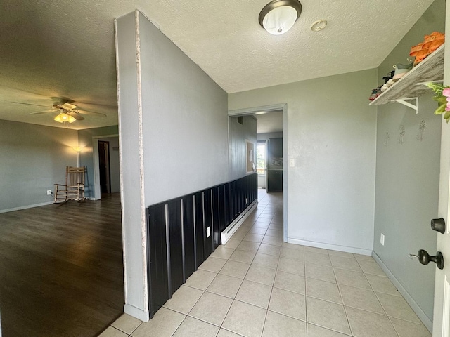 26812 US-150 Hwy, Leroy, IL 61752 - corridor with a textured ceiling, a baseboard heating unit, baseboards, and light tile patterned floors
