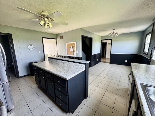 26812 US-150 Hwy, Leroy, IL 61752 - kitchen featuring a textured ceiling, light tile patterned flooring, dark cabinets, ceiling fan, and a chandelier