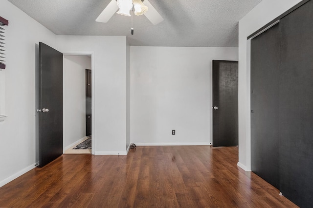 unfurnished bedroom featuring wood finished floors, a textured ceiling, a ceiling fan, and baseboards