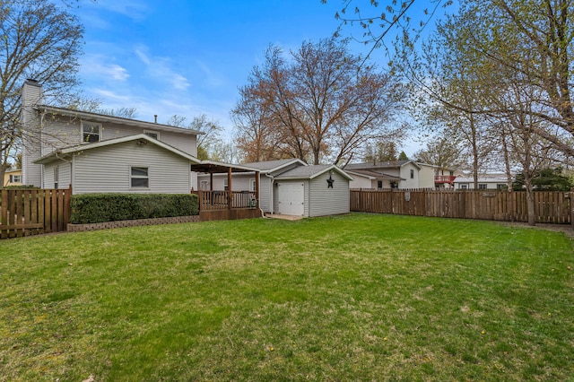 view of yard featuring a fenced backyard and an outbuilding