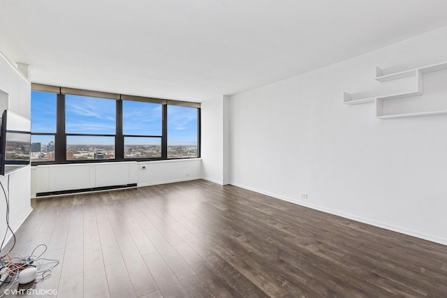 1560 N Sandburg Ter Unit 3207J, Chicago, IL 60610 - unfurnished living room featuring baseboards and dark wood-type flooring