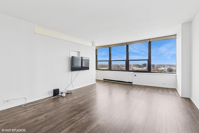 1560 N Sandburg Ter Unit 3207J, Chicago, IL 60610 - unfurnished living room with dark wood-style floors, baseboards, and a healthy amount of sunlight