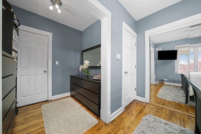 interior space featuring baseboards and wood finished floors