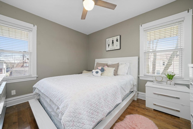 bedroom featuring a ceiling fan, baseboards, and wood finished floors