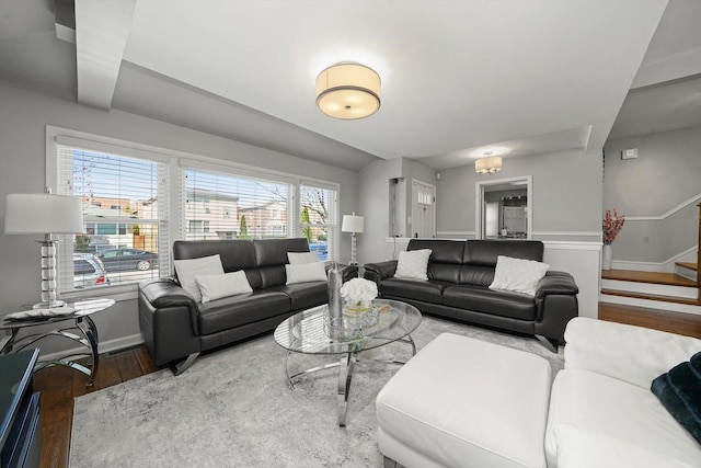 living area with stairway, baseboards, and wood finished floors