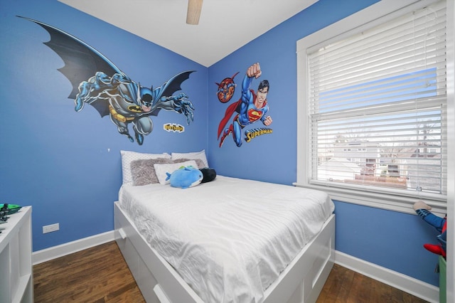 bedroom with baseboards, ceiling fan, and wood finished floors
