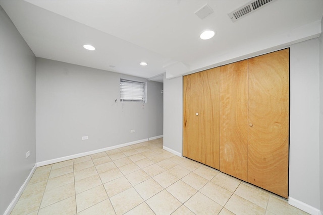 unfurnished bedroom with visible vents, baseboards, a closet, recessed lighting, and light tile patterned flooring