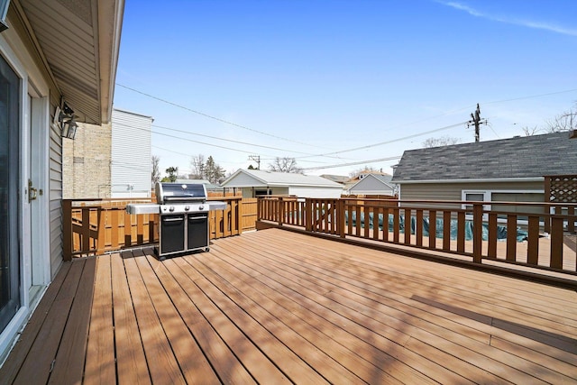 wooden terrace featuring a grill