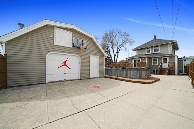 detached garage featuring fence