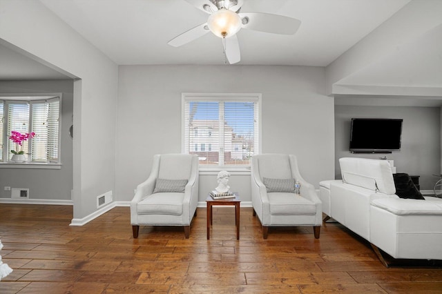 sitting room featuring baseboards, a ceiling fan, hardwood / wood-style flooring, and visible vents