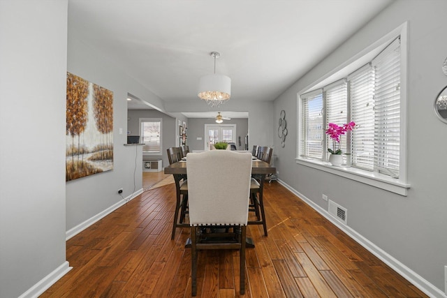 dining room with baseboards, wood-type flooring, and visible vents