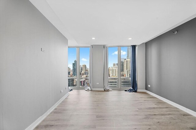 345 N La Salle Dr Unit 2501, Chicago, IL 60654 - empty room with recessed lighting, light wood-style flooring, baseboards, and a view of city