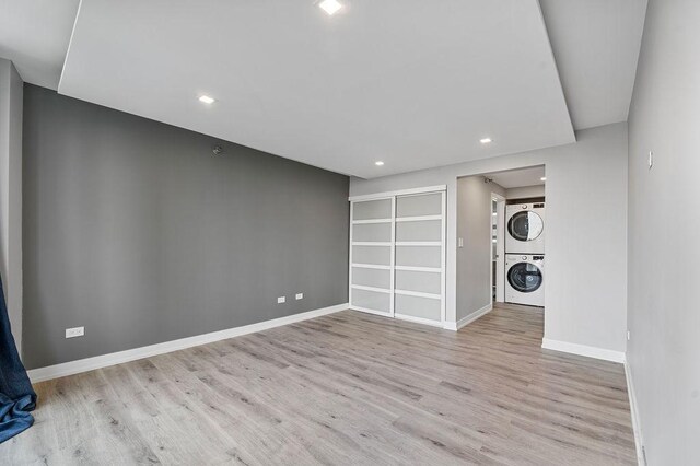 345 N La Salle Dr Unit 2501, Chicago, IL 60654 - basement with baseboards, wood finished floors, stacked washer and dryer, and recessed lighting
