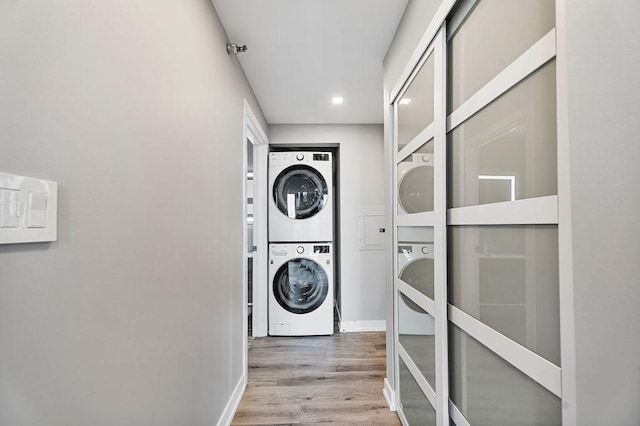 345 N La Salle Dr Unit 2501, Chicago, IL 60654 - washroom featuring wood finished floors, stacked washing maching and dryer, baseboards, laundry area, and recessed lighting