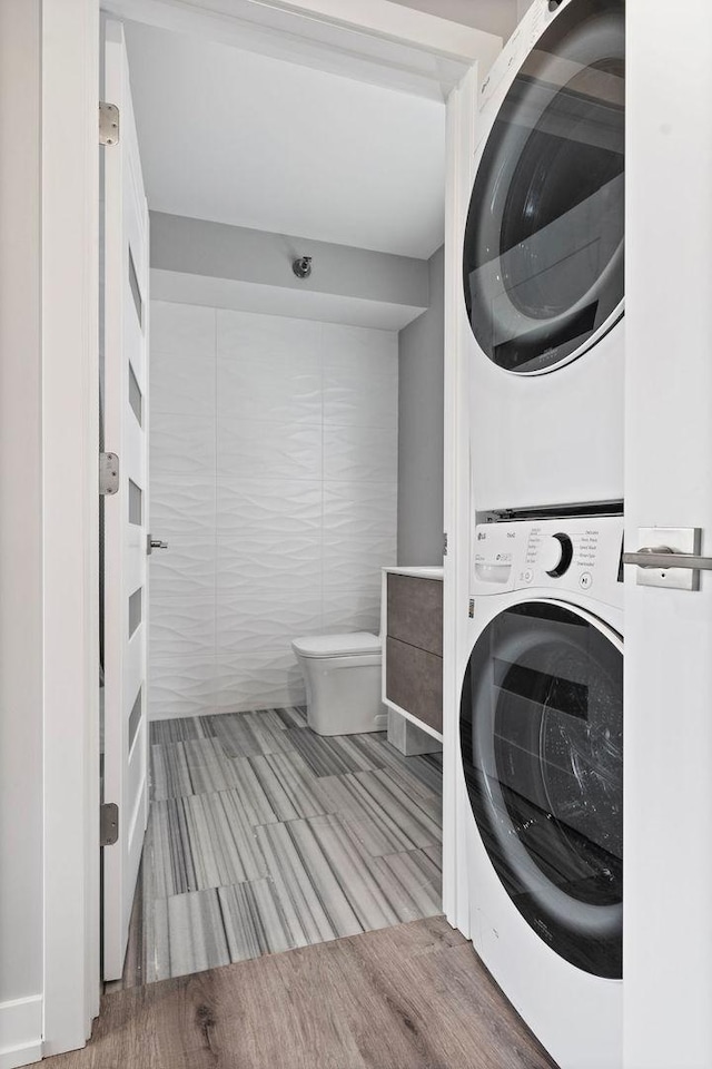 345 N La Salle Dr Unit 2501, Chicago, IL 60654 - washroom featuring stacked washer / drying machine, wood finished floors, and laundry area