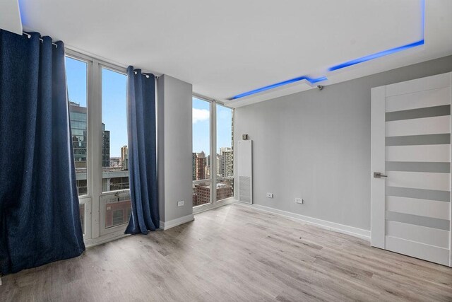 345 N La Salle Dr Unit 2501, Chicago, IL 60654 - spare room with baseboards, wood finished floors, and a view of city