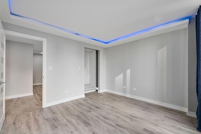 345 N La Salle Dr Unit 2501, Chicago, IL 60654 - spare room with baseboards, wood finished floors, and a tray ceiling