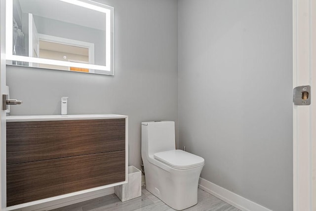 345 N La Salle Dr Unit 2501, Chicago, IL 60654 - bathroom featuring wood finished floors, baseboards, vanity, and toilet