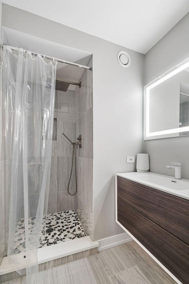 345 N La Salle Dr Unit 2501, Chicago, IL 60654 - full bathroom featuring baseboards, a shower stall, and vanity