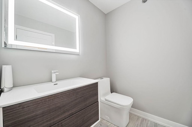 345 N La Salle Dr Unit 2501, Chicago, IL 60654 - bathroom featuring baseboards, wood finished floors, toilet, and vanity