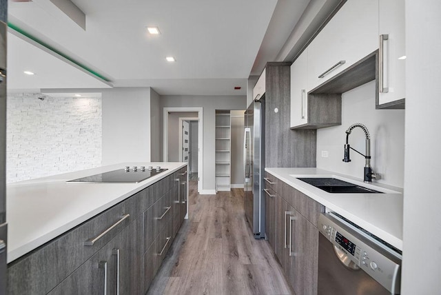 345 N La Salle Dr Unit 2501, Chicago, IL 60654 - kitchen with stainless steel appliances, light wood-style flooring, a sink, modern cabinets, and light countertops