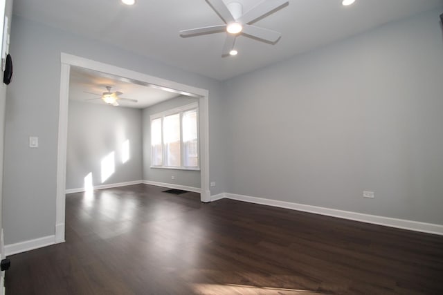spare room featuring a ceiling fan, dark wood-type flooring, recessed lighting, and baseboards