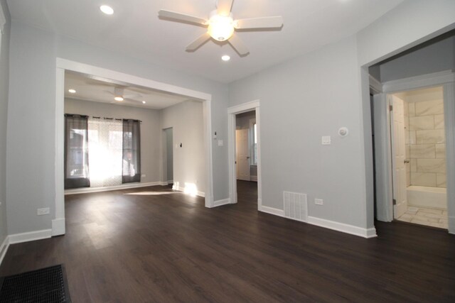 unfurnished living room featuring a ceiling fan, dark wood finished floors, baseboards, and recessed lighting