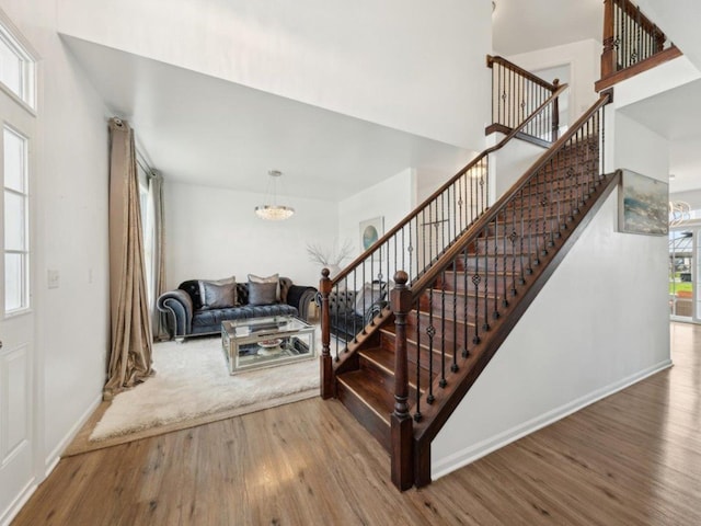 412 Towne Center Blvd, Shorewood, IL 60404 - stairs with an inviting chandelier, baseboards, and wood finished floors