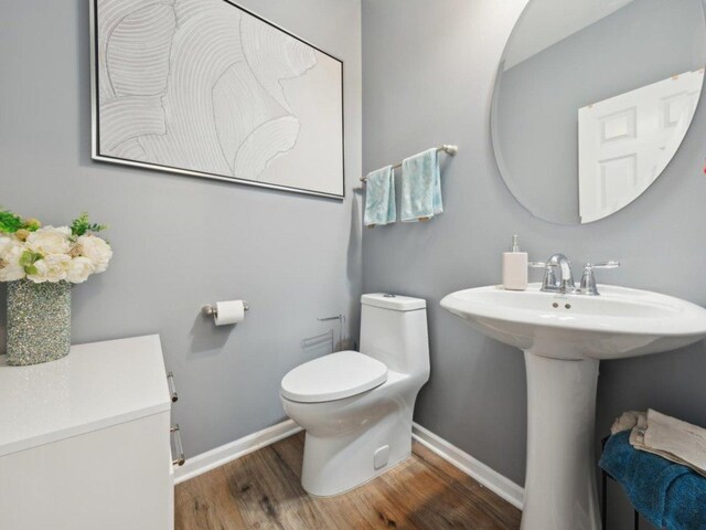 412 Towne Center Blvd, Shorewood, IL 60404 - half bathroom with toilet, wood finished floors, baseboards, and a sink