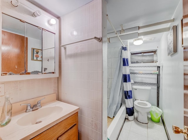 2936 N Kilpatrick Ave, Chicago, IL 60641 - full bath with vanity, tile walls, toilet, tile patterned flooring, and shower / bath combo with shower curtain