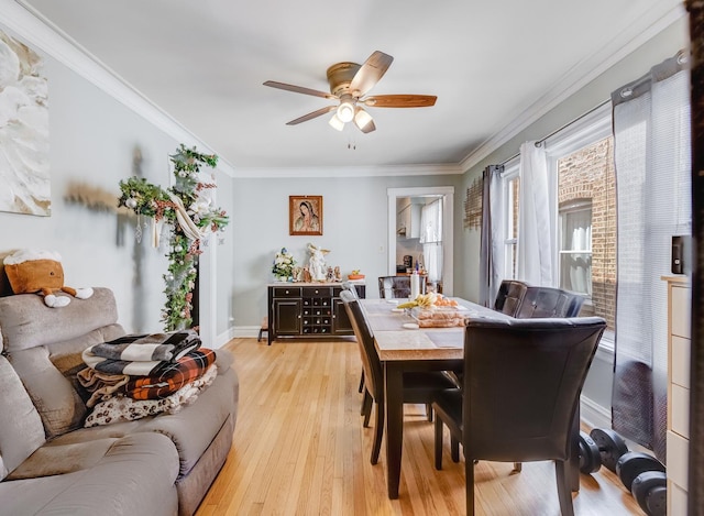 2936 N Kilpatrick Ave, Chicago, IL 60641 - dining area featuring baseboards, light wood-style flooring, ornamental molding, and a ceiling fan