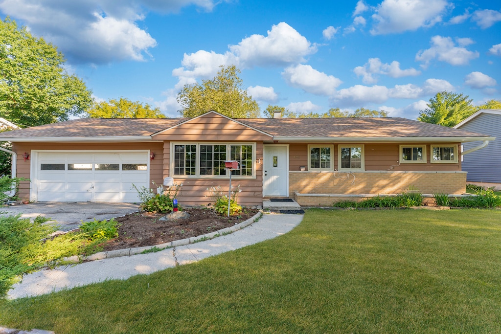 435 Douglas Rd, Batavia, IL 60510 - ranch-style house featuring an attached garage, driveway, a front lawn, and brick siding