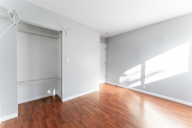 interior space with baseboards and wood finished floors