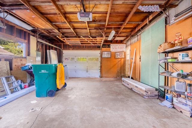 garage with a garage door opener and electric panel