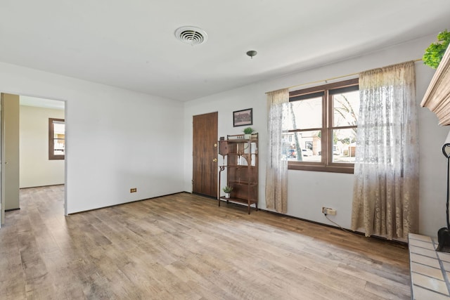 interior space with wood finished floors and visible vents