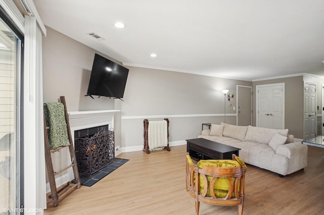 941 Yosemite Trl Unit C7, Roselle, IL 60172 - living area with light wood-style flooring, a warm lit fireplace, recessed lighting, baseboards, and crown molding