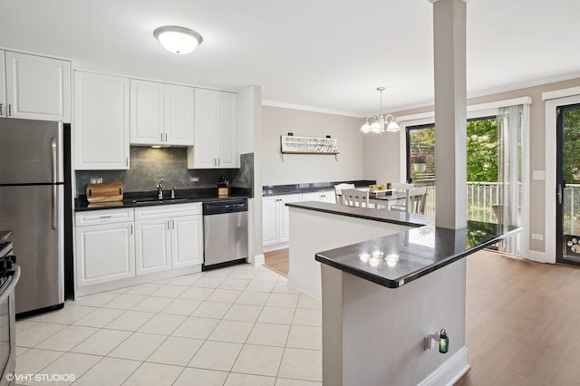 941 Yosemite Trl Unit C7, Roselle, IL 60172 - kitchen featuring appliances with stainless steel finishes, dark countertops, a sink, ornamental molding, and backsplash