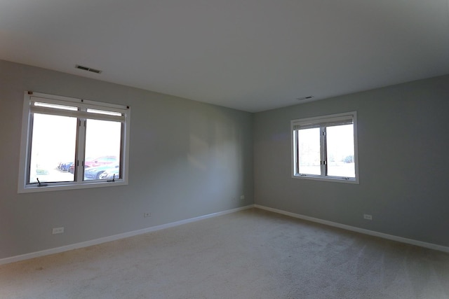 1503 N Milwaukee Ave Unit 2B, Libertyville, IL 60048 - unfurnished room featuring baseboards, visible vents, and light colored carpet
