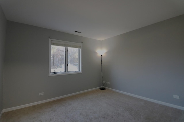 1503 N Milwaukee Ave Unit 2B, Libertyville, IL 60048 - unfurnished room featuring visible vents, light carpet, and baseboards