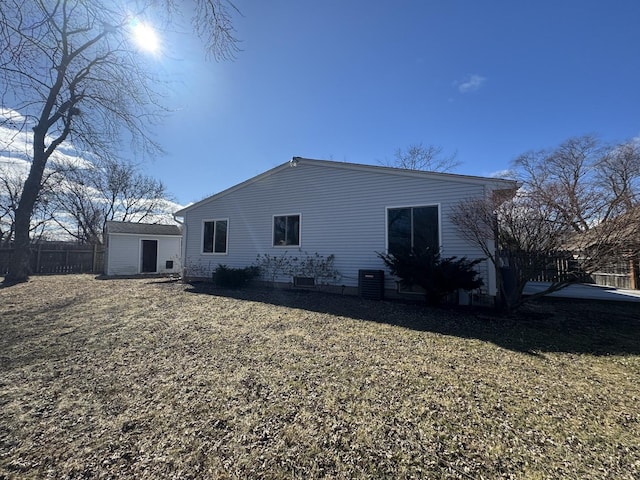 view of home's exterior featuring fence, a yard, and central AC unit