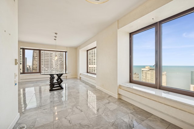 161 E Chicago Ave Unit 32A, Chicago, IL 60611 - corridor with a water view, marble finish floor, baseboards, and a notable chandelier