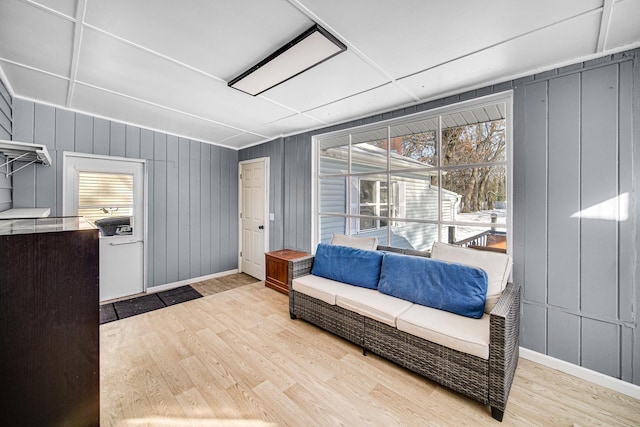 living area featuring light wood-style flooring and baseboards