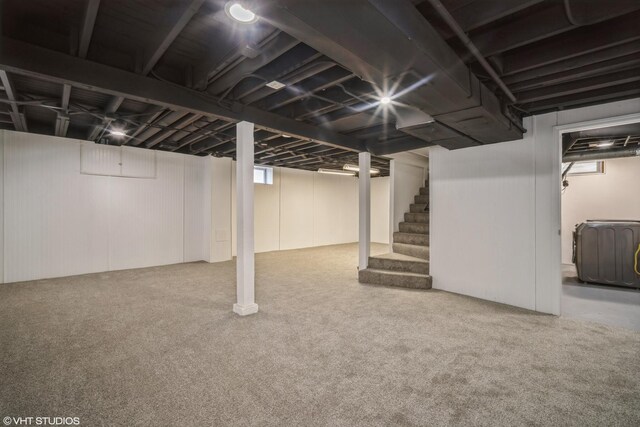 below grade area featuring carpet floors and stairs