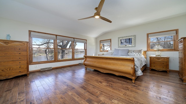 bedroom with a ceiling fan, baseboards, wood-type flooring, lofted ceiling, and visible vents