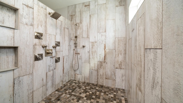 full bath featuring a tile shower