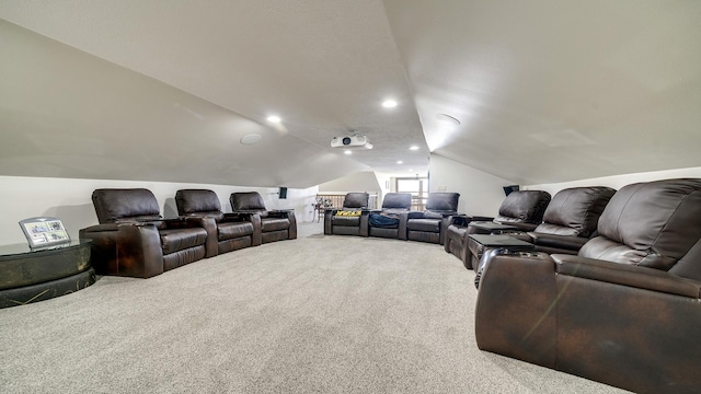 carpeted cinema with lofted ceiling and recessed lighting