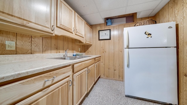 kitchen with light carpet, light brown cabinetry, a sink, freestanding refrigerator, and light countertops